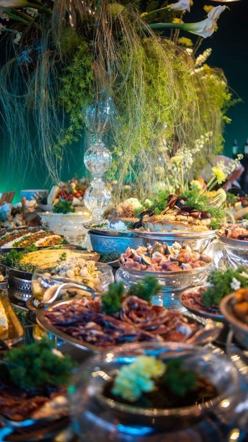A buffet counter decorated with greens