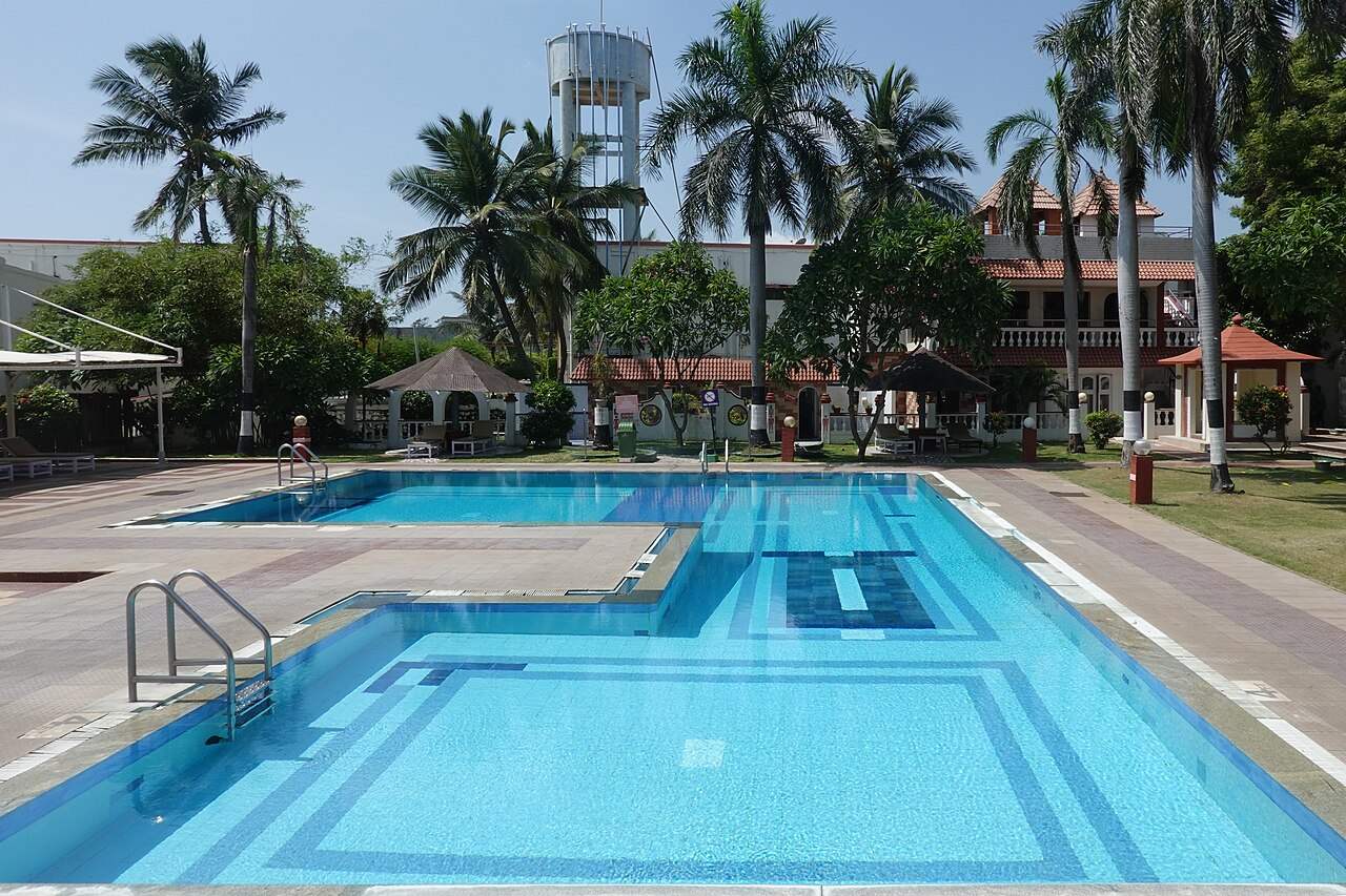 Blue resort pool with palm trees