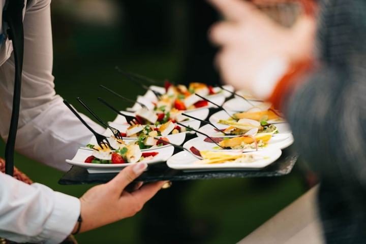 Waiter serving canapés on a tray