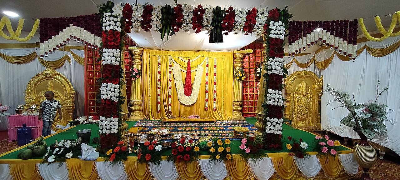 A floral wedding stage with marigold garlands